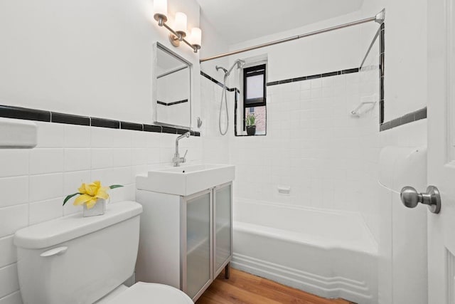 15 Oliver St Unit 3C, Brooklyn, NY 11209 - bathroom featuring toilet, shower / bathtub combination, vanity, tile walls, and wood finished floors