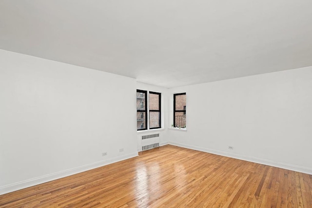 15 Oliver St Unit 3C, Brooklyn, NY 11209 - empty room featuring radiator heating unit, light wood-style floors, and baseboards