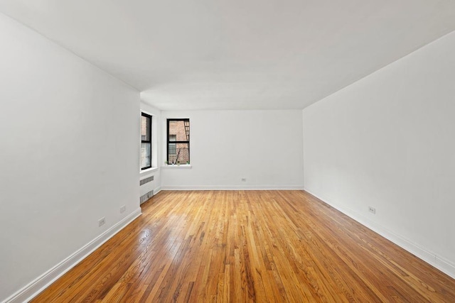 15 Oliver St Unit 3C, Brooklyn, NY 11209 - spare room with radiator heating unit, hardwood / wood-style floors, and baseboards