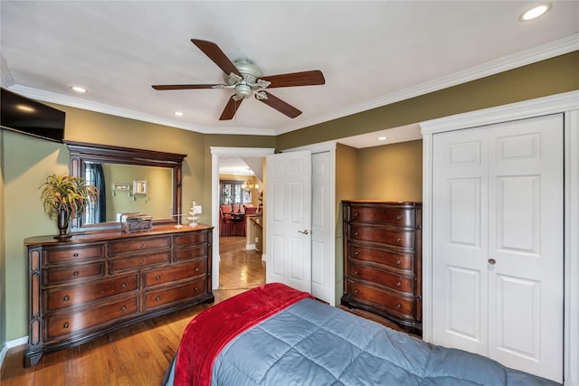 2193 Post St, East Meadow, NY 11554 - bedroom featuring two closets, wood finished floors, crown molding, baseboards, and recessed lighting
