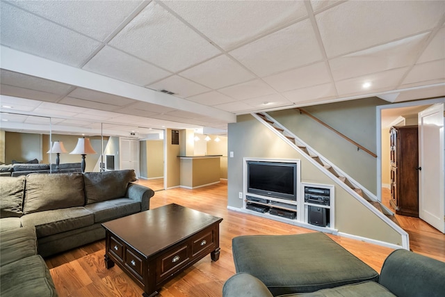 2193 Post St, East Meadow, NY 11554 - living room with stairs, light wood-type flooring, a drop ceiling, baseboards, and recessed lighting