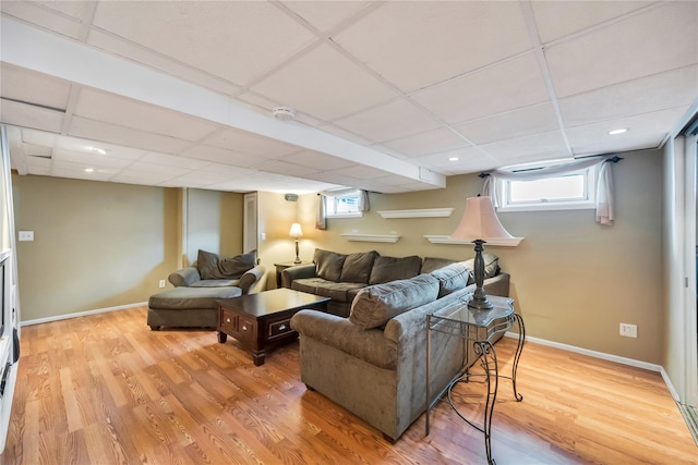 2193 Post St, East Meadow, NY 11554 - living room featuring a drop ceiling, light wood-style flooring, plenty of natural light, and baseboards