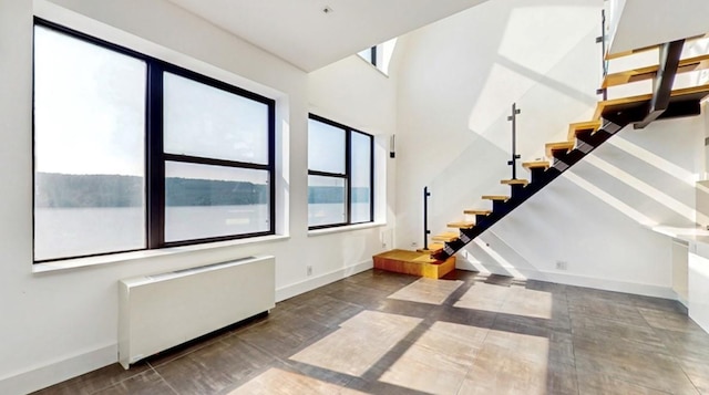 23 Water Grant St Unit 10D, Yonkers, NY 10701 - stairs featuring baseboards, radiator, and a towering ceiling