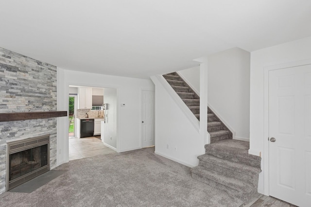 18 Taylor Commons, Yaphank, NY 11980 - unfurnished living room featuring stairway, carpet, a fireplace, and baseboards