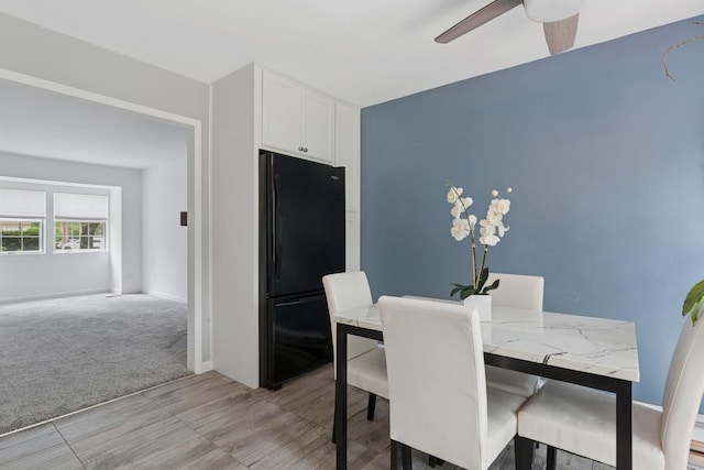 18 Taylor Commons, Yaphank, NY 11980 - dining area featuring ceiling fan, baseboards, light wood-type flooring, and light carpet