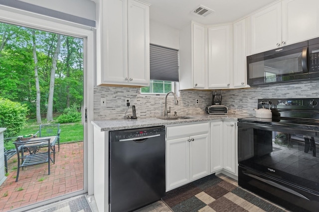 18 Taylor Commons, Yaphank, NY 11980 - kitchen with black appliances, a sink, tasteful backsplash, and white cabinetry