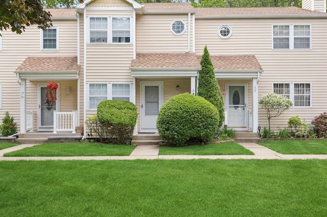 18 Taylor Commons, Yaphank, NY 11980 - view of property with a shingled roof and a front lawn