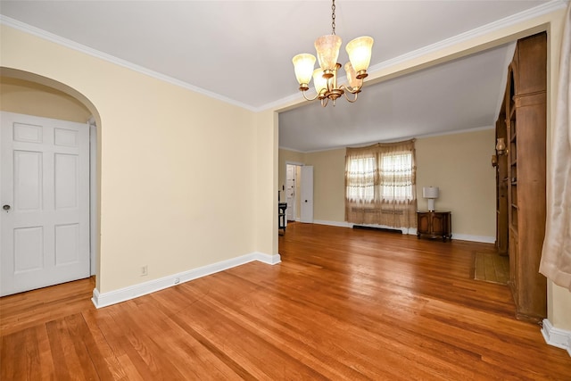 86-32 Avon St, Jamaica Estates, NY 11432 - empty room featuring light wood-style floors, a chandelier, crown molding, baseboards, and arched walkways