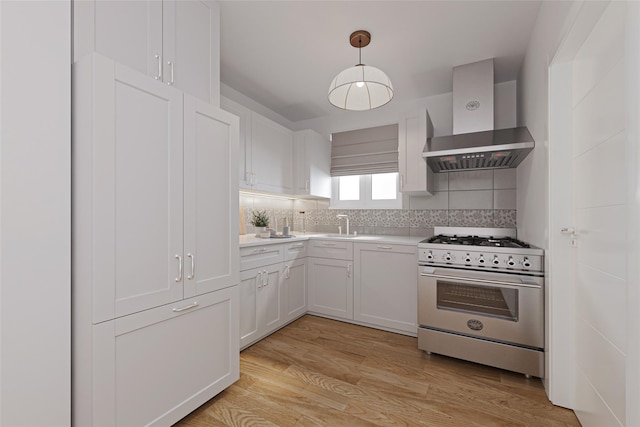 86-32 Avon St, Jamaica Estates, NY 11432 - kitchen with high end stove, island exhaust hood, decorative backsplash, light wood finished floors, and white cabinets