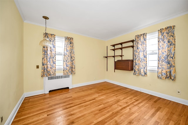 86-32 Avon St, Jamaica Estates, NY 11432 - spare room featuring radiator, light wood-type flooring, baseboards, and crown molding