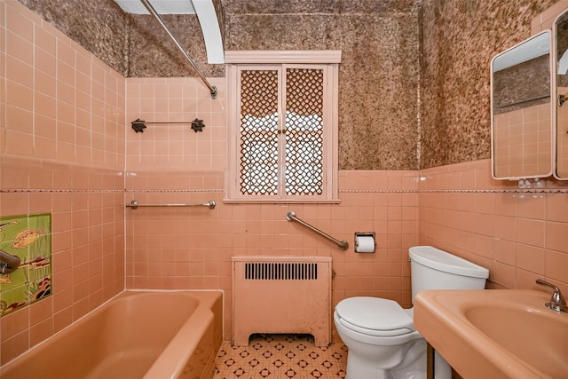86-32 Avon St, Jamaica Estates, NY 11432 - bathroom featuring radiator heating unit, toilet, tile walls, a sink, and tile patterned flooring
