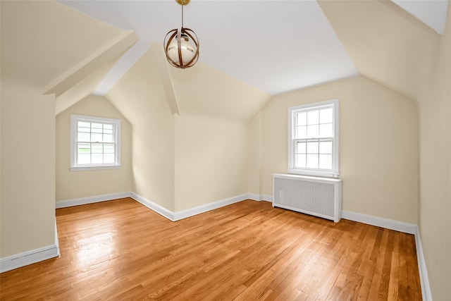 86-32 Avon St, Jamaica Estates, NY 11432 - additional living space featuring radiator heating unit, light wood-style flooring, vaulted ceiling, and baseboards