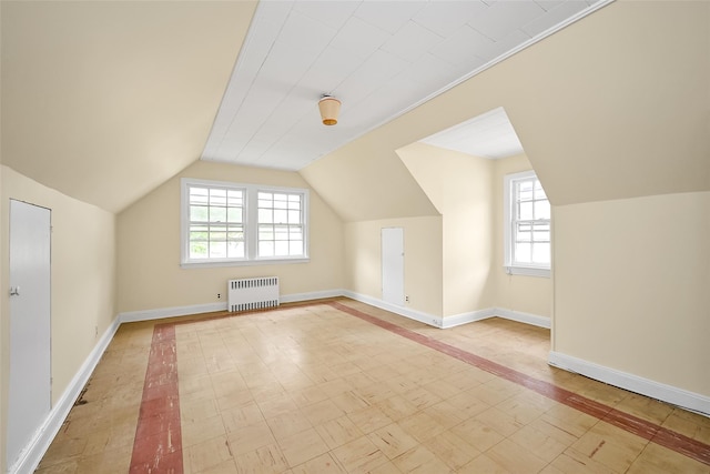 86-32 Avon St, Jamaica Estates, NY 11432 - additional living space with radiator heating unit, vaulted ceiling, baseboards, and inlaid floor details