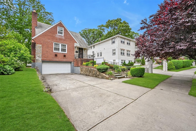 86-32 Avon St, Jamaica Estates, NY 11432 - view of front of house featuring brick siding, a chimney, driveway, a front lawn, and a garage
