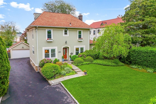 755 Webster Ave, New Rochelle, NY 10804 - view of front of property featuring an outdoor structure, a garage, a chimney, a front lawn, and stucco siding