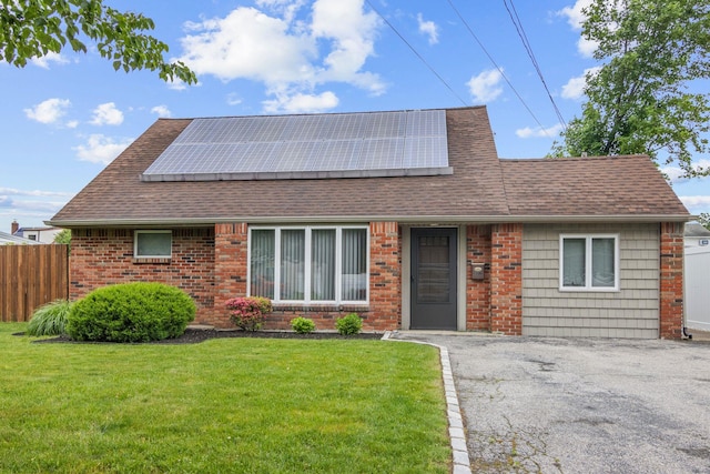 2287 7th St, East Meadow, NY 11554 - view of front of property featuring a shingled roof, roof mounted solar panels, and brick siding