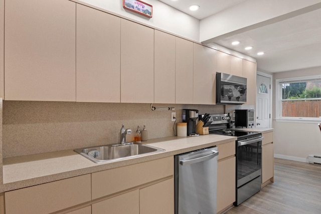 2287 7th St, East Meadow, NY 11554 - kitchen with stainless steel appliances, a sink, light countertops, decorative backsplash, and recessed lighting