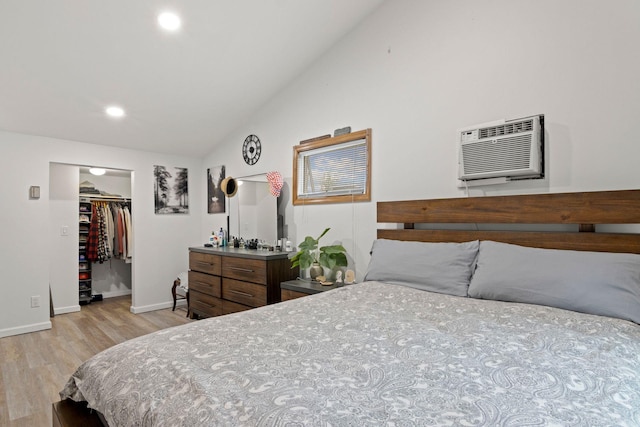 2287 7th St, East Meadow, NY 11554 - bedroom with a wall unit AC, light wood finished floors, baseboards, a walk in closet, and recessed lighting