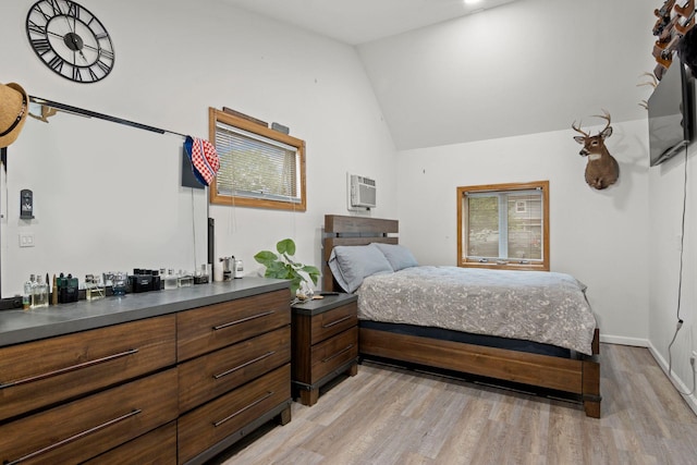 2287 7th St, East Meadow, NY 11554 - bedroom with light wood-type flooring, a wall mounted AC, and high vaulted ceiling
