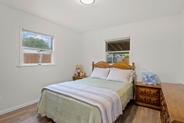 2287 7th St, East Meadow, NY 11554 - bedroom featuring multiple windows, wood finished floors, and baseboards