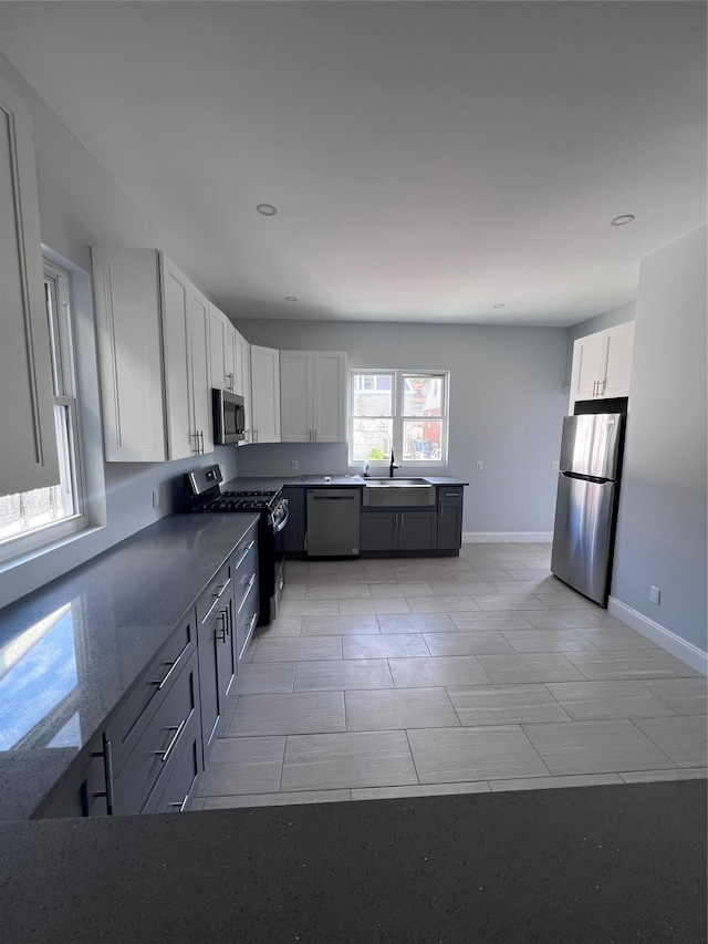 61 Edgewood Ave, Yonkers, NY 10704 - kitchen featuring stainless steel appliances, white cabinetry, a sink, recessed lighting, and baseboards