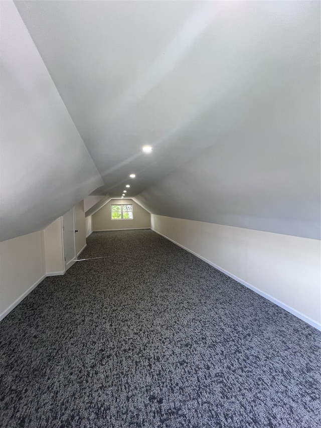 61 Edgewood Ave, Yonkers, NY 10704 - bonus room with lofted ceiling, dark carpet, and baseboards
