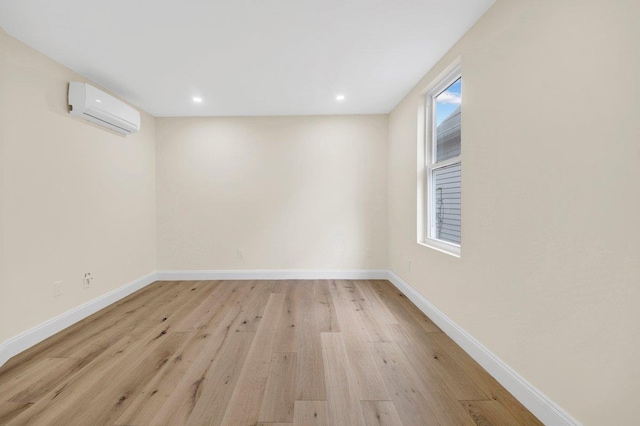 61 Edgewood Ave, Yonkers, NY 10704 - unfurnished room featuring an AC wall unit, light wood-type flooring, baseboards, and recessed lighting