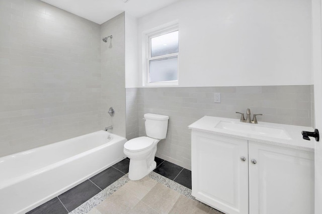 61 Edgewood Ave, Yonkers, NY 10704 - full bathroom featuring toilet, shower / washtub combination, vanity, tile walls, and tile patterned floors