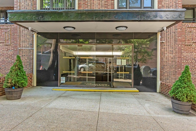 123-35 82nd Rd Unit 4H, Kew Gardens, NY 11415 - doorway to property with brick siding and a security system