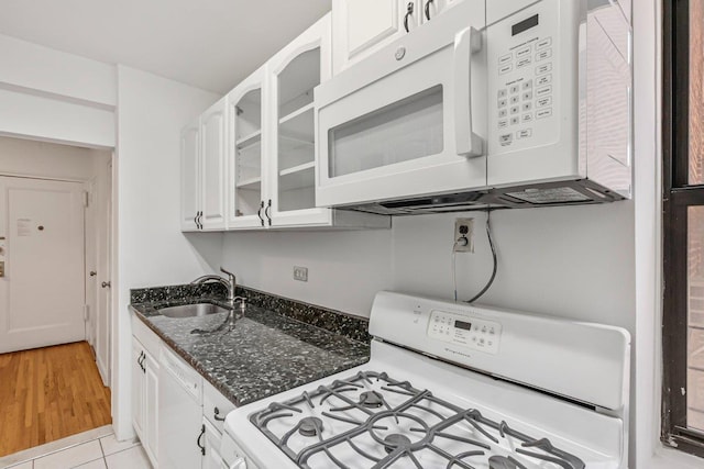 123-35 82nd Rd Unit 4H, Kew Gardens, NY 11415 - kitchen with white appliances, a sink, glass insert cabinets, white cabinetry, and dark stone counters