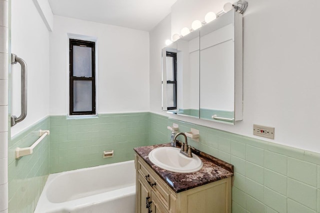 123-35 82nd Rd Unit 4H, Kew Gardens, NY 11415 - full bath with tile walls, a wainscoted wall, vanity, and a tub