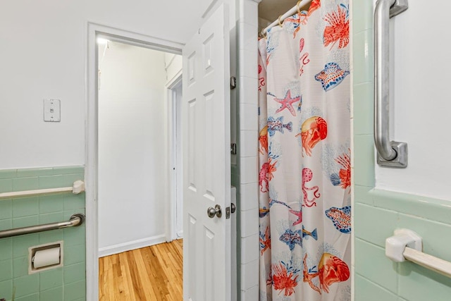 123-35 82nd Rd Unit 4H, Kew Gardens, NY 11415 - full bathroom featuring wood finished floors, a shower with shower curtain, and tile walls