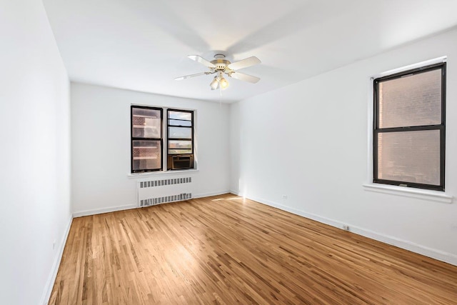 123-35 82nd Rd Unit 4H, Kew Gardens, NY 11415 - empty room featuring radiator heating unit, wood finished floors, ceiling fan, and baseboards