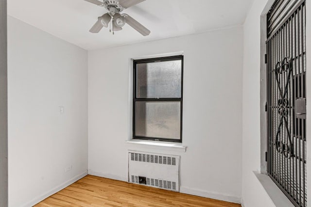 123-35 82nd Rd Unit 4H, Kew Gardens, NY 11415 - empty room with radiator heating unit, light wood finished floors, a ceiling fan, and baseboards