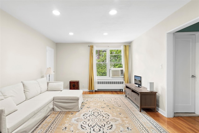 82U Glen Keith Rd Unit 82U, Glen Cove, NY 11542 - living room featuring radiator heating unit, light wood-type flooring, recessed lighting, baseboards, and cooling unit