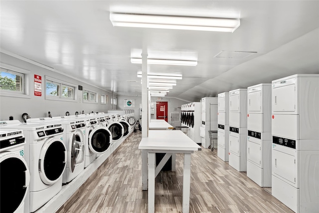 82U Glen Keith Rd Unit 82U, Glen Cove, NY 11542 - communal laundry room with stacked washer / dryer, light wood-style flooring, and washing machine and clothes dryer