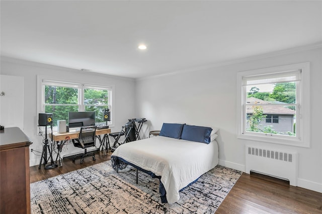 45 Pool Dr, Roslyn, NY 11576 - bedroom featuring radiator heating unit, ornamental molding, an office area, wood finished floors, and baseboards