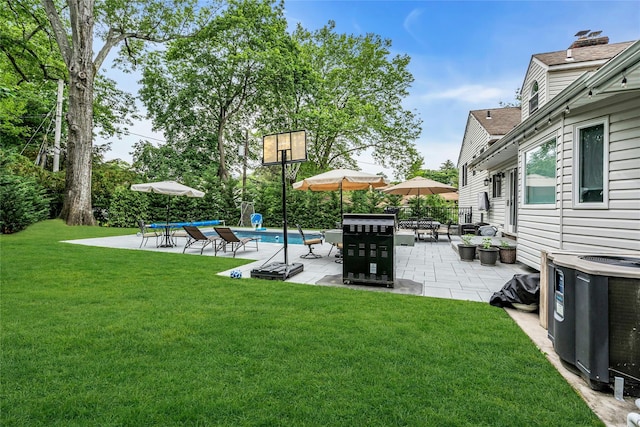 45 Pool Dr, Roslyn, NY 11576 - view of green lawn with central AC unit and a patio