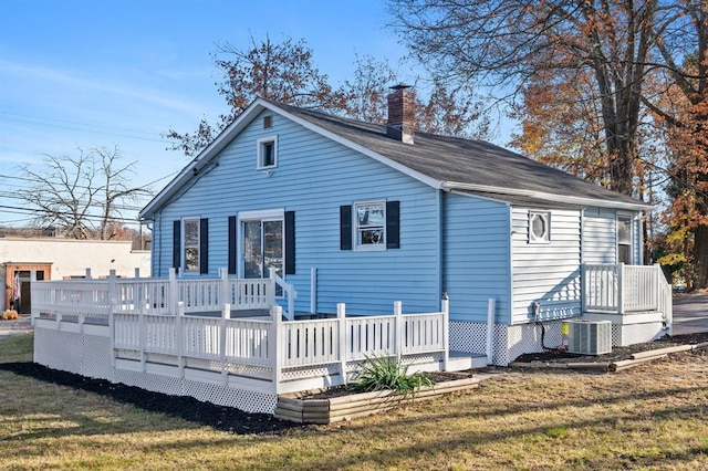 945 Homestead Ave, Maybrook, NY 12543 - back of house with a chimney, a lawn, central AC, and a deck