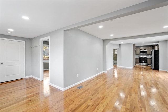 945 Homestead Ave, Maybrook, NY 12543 - unfurnished living room featuring baseboards, light wood-type flooring, recessed lighting, and arched walkways