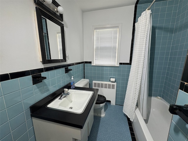 53 Canterbury Ln, North Babylon, NY 11703 - full bath featuring radiator heating unit, tile walls, toilet, vanity, and wainscoting
