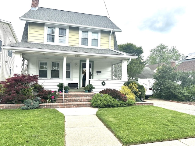 138 Oceanview Rd, East Rockaway, NY 11518 - view of front of property featuring a porch, a front yard, a chimney, and roof with shingles