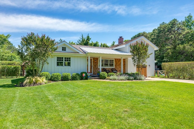 2 Longview Rd, Southampton, NY 11968 - view of front of home with a porch, board and batten siding, a chimney, and driveway