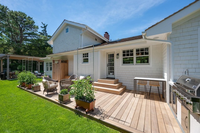 2 Longview Rd, Southampton, NY 11968 - back of property featuring a wooden deck, a chimney, and a lawn