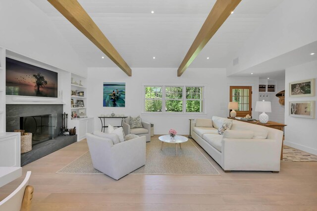 2 Longview Rd, Southampton, NY 11968 - living room featuring a fireplace with raised hearth, baseboards, wood finished floors, recessed lighting, and built in shelves