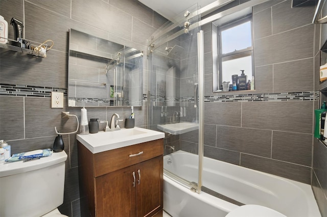 60 Barker St Unit 417, Mount Kisco, NY 10549 - full bathroom featuring toilet, vanity, tile walls, bath / shower combo with glass door, and decorative backsplash