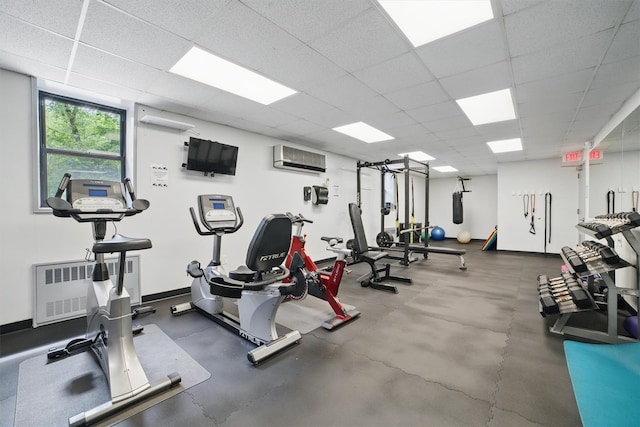 60 Barker St Unit 417, Mount Kisco, NY 10549 - workout area featuring radiator, a drop ceiling, a wall mounted AC, and baseboards