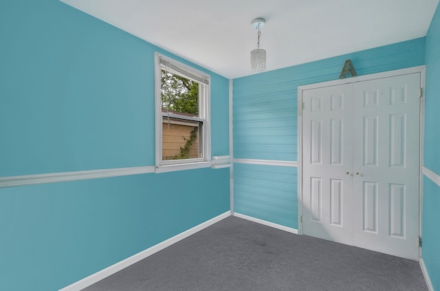 96 Toomey Rd, West Islip, NY 11795 - unfurnished bedroom featuring a closet, dark colored carpet, and baseboards