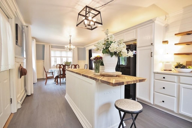 3454 State Route 208, Campbell Hall, NY 10916 - kitchen with butcher block countertops, a chandelier, dark wood finished floors, white cabinetry, and a decorative wall