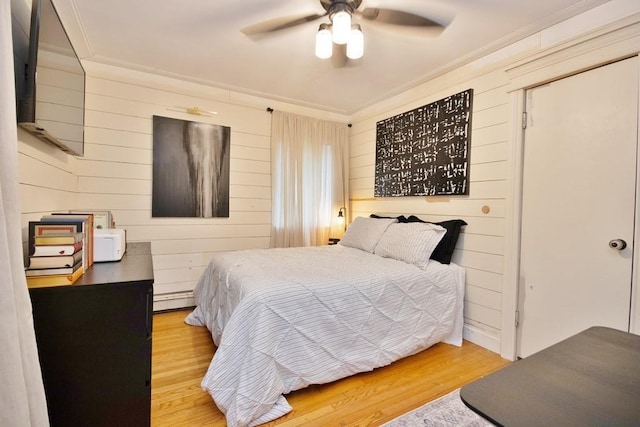 3454 State Route 208, Campbell Hall, NY 10916 - bedroom with ornamental molding, wood finished floors, a baseboard radiator, wood walls, and ceiling fan